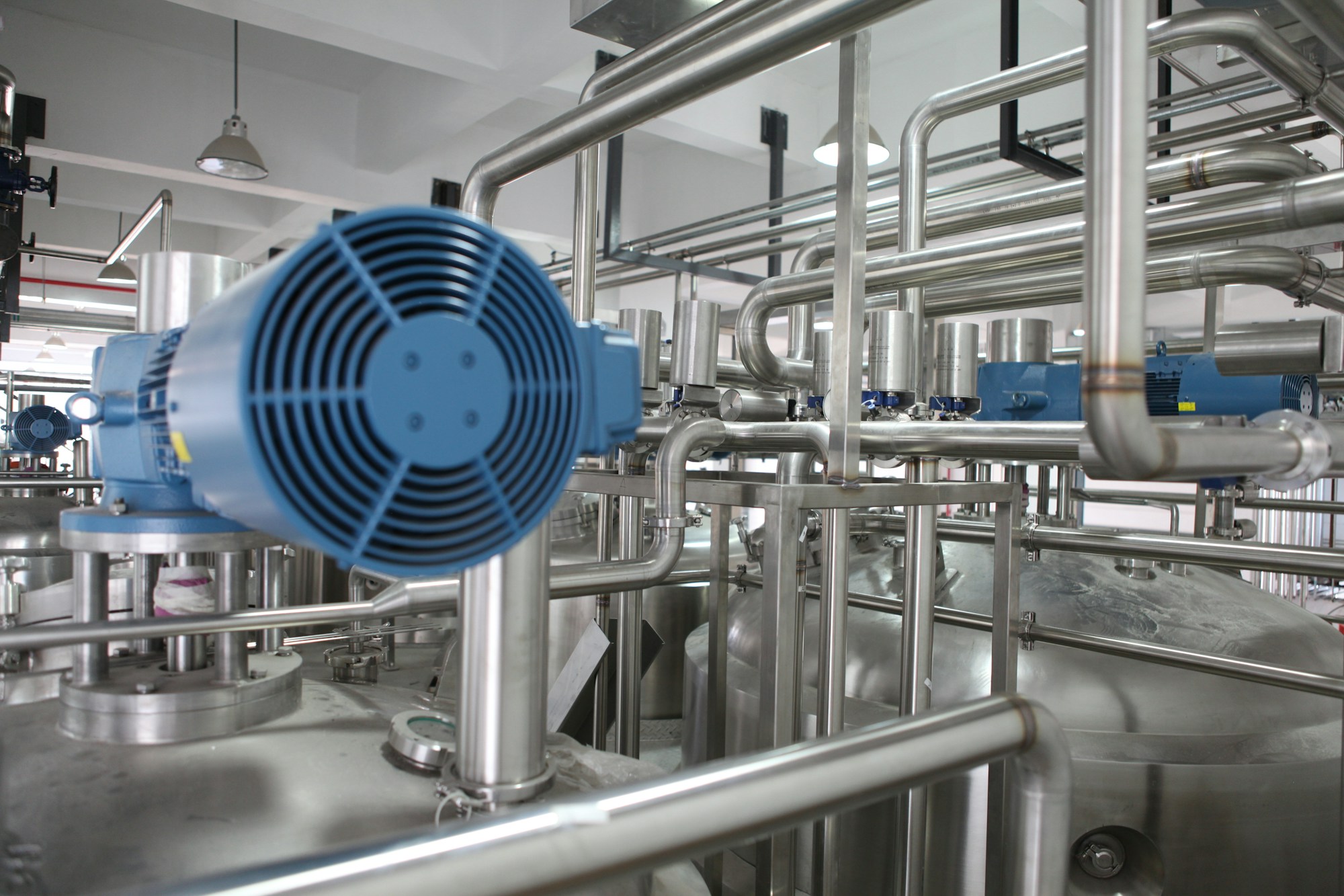 Industrial equipment and stainless steel pipework inside an operating facility
